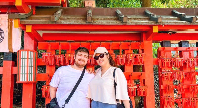 Couple In Front Of Red Japanese Gate At Fushimi Inari Shrine In Kyoto Japan On A Kyoto Day Tour