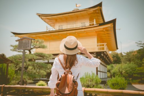 Female Tourist Admiring The Golden Pavilion In Kyoto