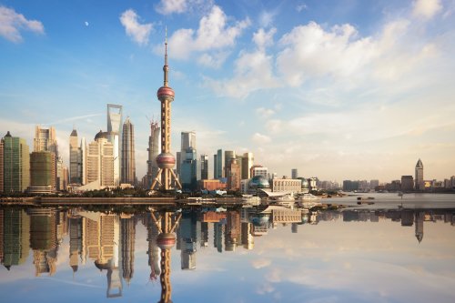 Shanghai Skyline At Dusk With Reflection On The Water